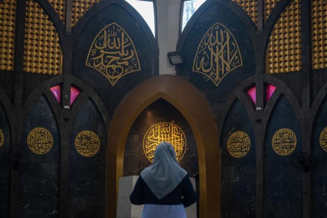 A Muslim woman seen performing the Eid al-Fitr prayer at the Islamic center of Thailand. 